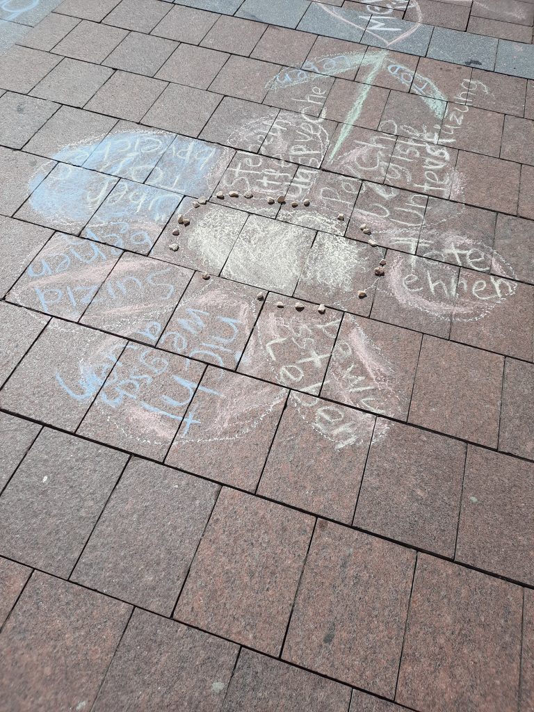 Straßenaktion Jugend im Fokus: Blume mit mit Inschrift (z.B. "bewusst leben", "nicht wegschauen")